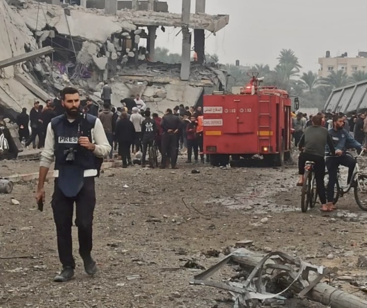 Palestinian Journalist Motaz Azaiza seen with local residents and rescue forces in Deir Al Balah