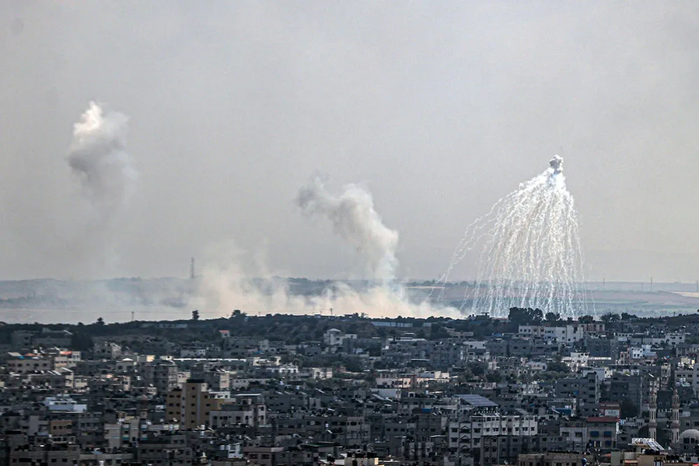 Smoke rises above the Gaza Strip after an alleged white phosphorus attack by Israel on October 11 [Ali Jadallah/Anadolu]